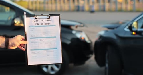 Close Up of a Man Car Insurance Agent Inspecting Damaged Car with Insurance Claim Form Insurance
