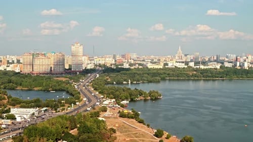 Aerial View of Cityscape with Lake and Traffic