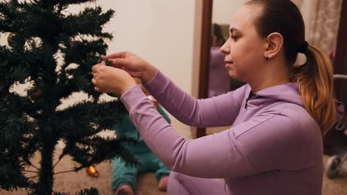 Mother and Child Decorating Christmas Tree Together