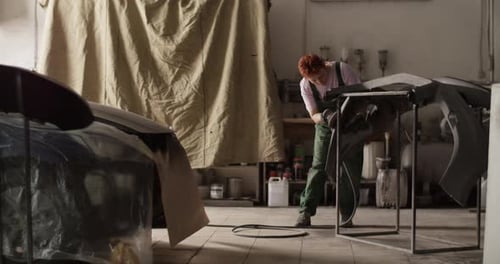 Female Painter Working in Sunlit Garage