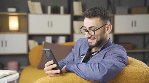 Happy man using phone.