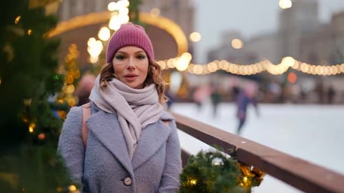 Rest in City in Christmas Vacation Woman Standing Near Ice Rink on Town Square in Winter