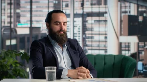 Businessman Reviewing Documents in Modern City Office