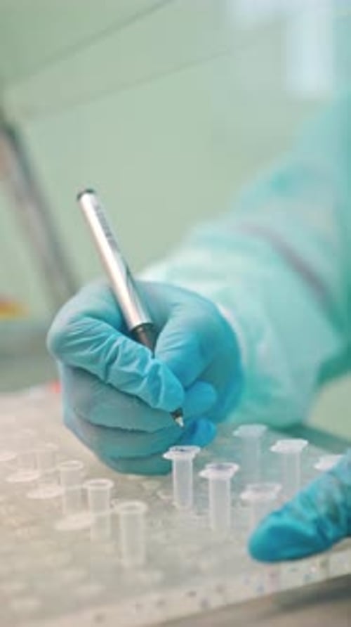 Lab Technician Labeling Test Tubes in Clinical Setting