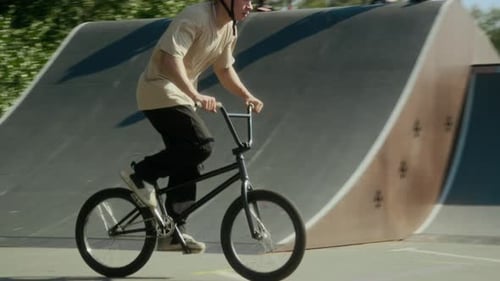 BMX Rider Performing Barspin Trick in Air at Skate Park