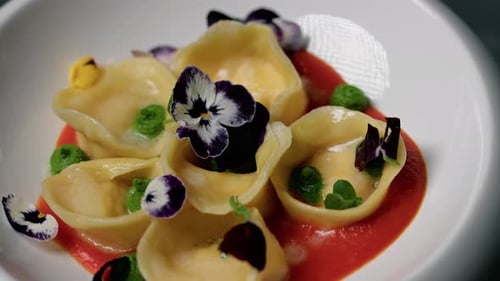 Colorful Cappelletti Pasta With Tomato Cream And Flowers