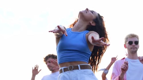 Close Up of Cheerful Young Attractive Woman Dancing and Jumping Having Fun at Summer Party on a Roof
