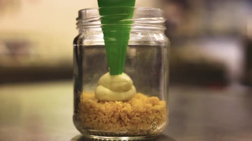 Delicious dessert with pastry ice cream inside glass jar in shop kitchen