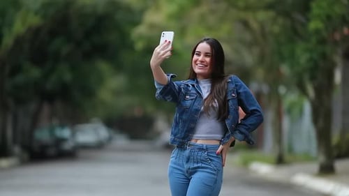 Smiling Woman Takes Selfie on Suburban Street