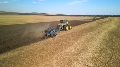 Tractors plowing the field in Ukraine