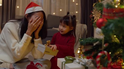 Asian family merry christmas and happy new year holiday. Mom and daughter enjoy christmas night.