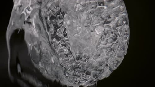 Clean Water Pouring In Transparent Wineglass With Black Background Close Up. Swirling Drink Splas...