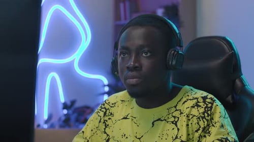 Face of Black Gamer Playing and Sipping Energy Drink