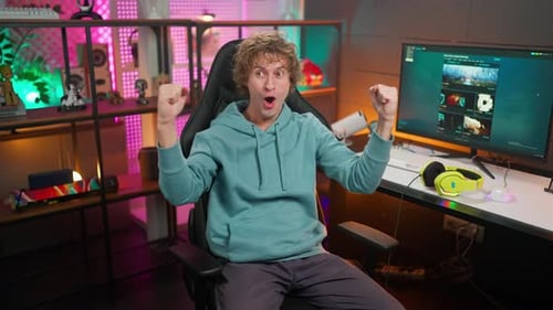 Excited Gamer Celebrates Victory in a Colorful Room