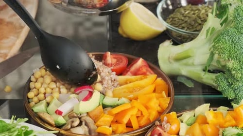 Close-up of a chef using a kitchen spoon to put chickpeas on a plate. Cooking, healthy vegan food co