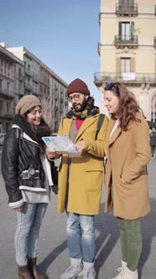 Friends Looking at Map in City Center