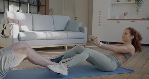 Joyful Couple Man and Woman Doing Sports Together Working Out Indoors in Apartment