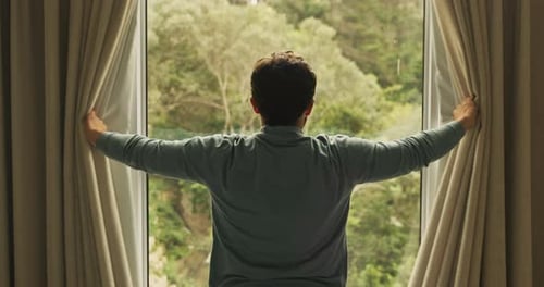 Hotel, man and open curtains with stretching for wake up, morning routine or check weather