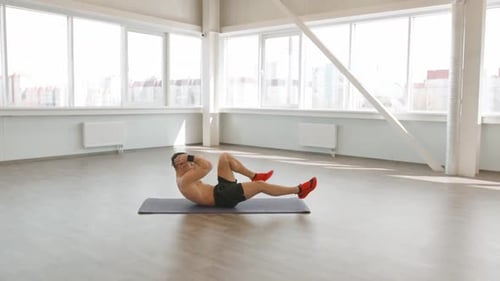 Man Doing Abdominal Workout in a Gym