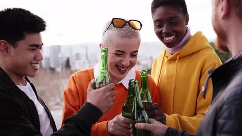 Friends Drinking Beer at Terrace Outdoors on Weekend Friendship Concept with Young People Having Fun