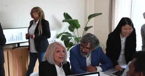Multiracial business team collaborating on startup strategy inside bank office