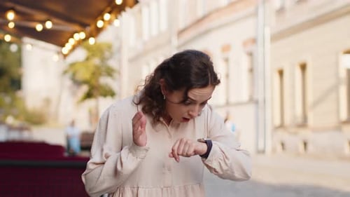 Young Woman Checks Watch, Runs Late in City