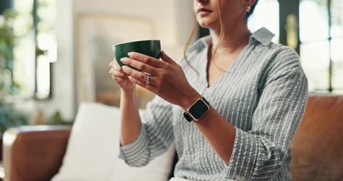 Woman Sipping from Mug in Cozy Living Room