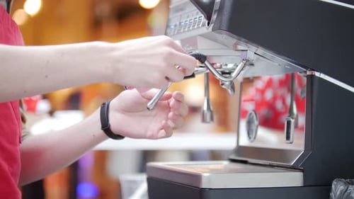 Barista Working with a Coffee Machine in a Coffee Shop