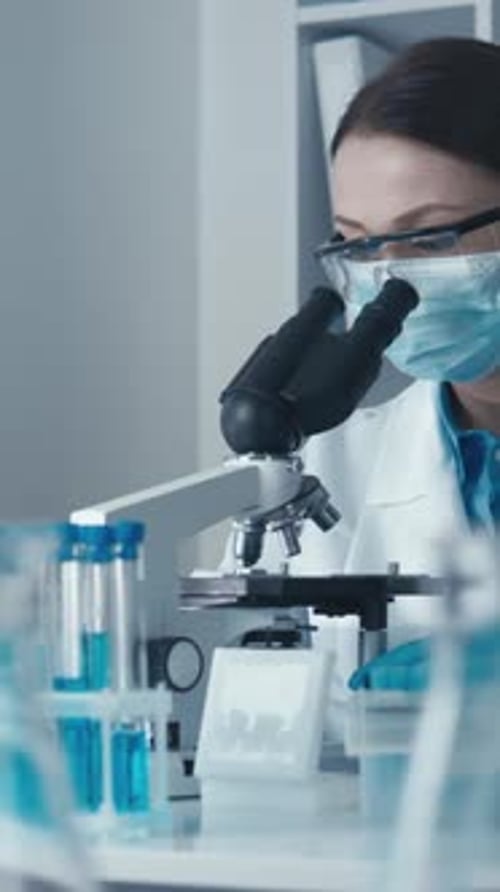 Scientist Using Microscope in Lab Setting