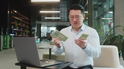 Upset Businessman Feeling Worried About Financial Problems Bad Day Sitting in Modern Office Lobby