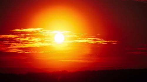Timelapse of Dramatic Sunset Through Clouds in the Orange Sky Over the Horizon