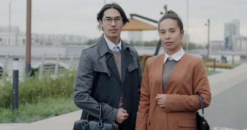 Slow Motion Portrait of Business Man and Woman Partners Standing Together in City and Looking at