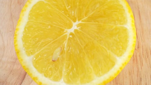Bright Yellow Lemon Slice on Wooden Board