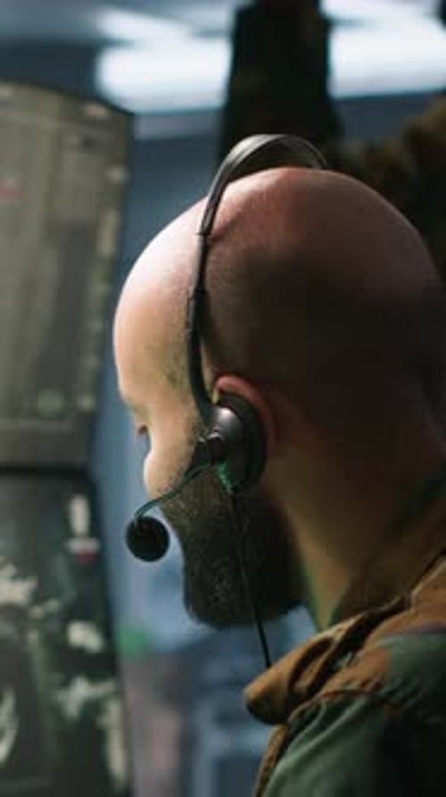 Man in Camo Jacket Wearing Headset in Office