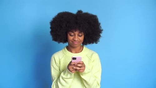 Smiling Black Woman Using Smartphone