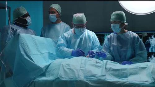 Team of Professional Medical Surgeons Performs the Surgical Operation in a Modern Hospital Doctors