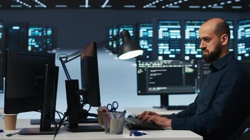 Programmer Coding at Computer in a Futuristic Office