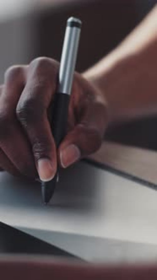A CloseUp View of a Hand Engaged in Writing with a Pen on Paper in Great Detail