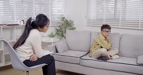 Child Speaking With Therapist in Office Setting