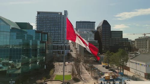 Canadian Flag Waving in City Aerial View
