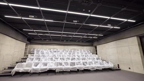 Empty Theater Hall, Seats Covered with Plastic Cover