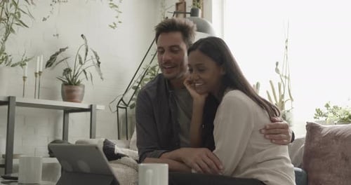 Couple Video Chatting at Home on a Tablet