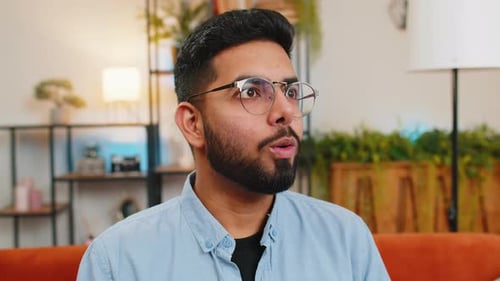 Bearded Man Reacts with Joy and Excitement Indoors