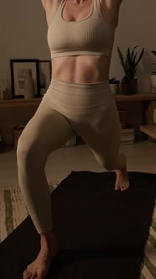 Young Adult Woman Doing Yoga at Home