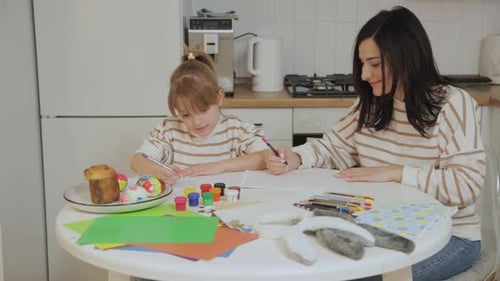 Family Drawing Easter Decorations in the Kitchen