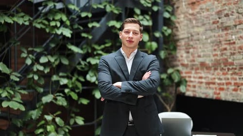 Confident Businessman in Modern Office Exuding Professionalism and Success