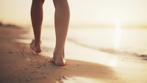 Slim Fit Legs of Woman Tourist Barefooted Feet Walking on Sandy Ocean Beach in Luxury Resort at