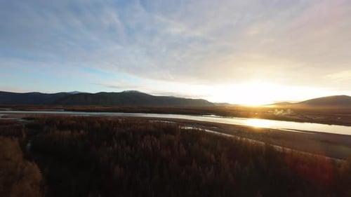 Tranquil River and Mountain Landscape at Sunrise