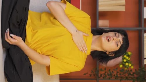 Vertical video of Young woman with shortness of breath.