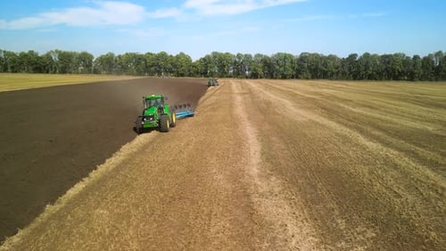 Tractors plowing the field in Ukraine